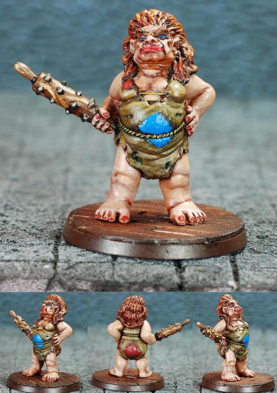 Painted miniature of a red-haired female warrior with spear and blue shield.