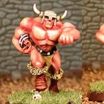 Two horned, muscular red minotaur miniatures on a stone-floor background.