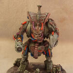Painted sci-fi monster miniature with guns on a round base