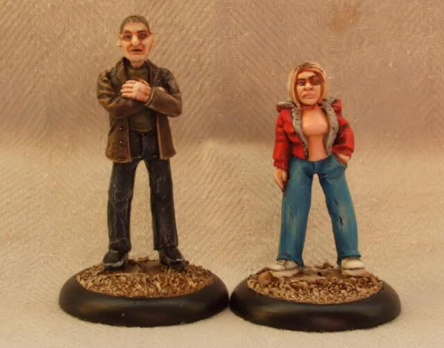 Two painted miniature figures, a man and a woman, standing on round bases.