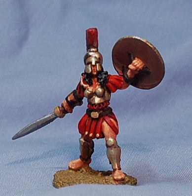 Photo of a painted miniature warrior in red armor, holding a sword and round shield.