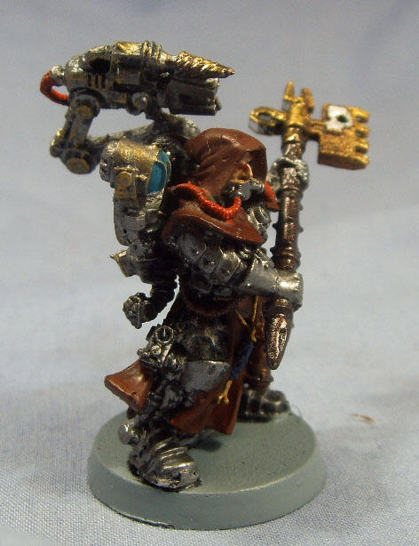 Painted fantasy rat warrior miniature with staff and red cape on a gray base.