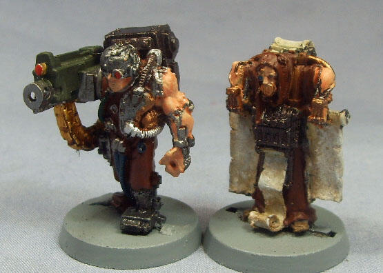 Two painted sci-fi soldier miniatures with large backpacks and heavy weapons.