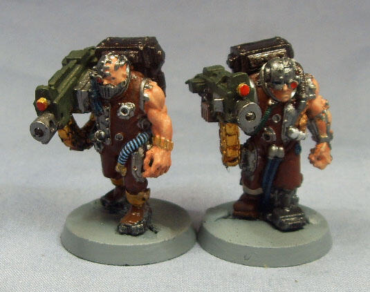 Two painted sci-fi soldier miniatures with bulky backpacks on gray bases.