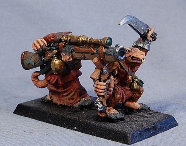 Photo of two painted fantasy goblin miniatures with tools on a black base.