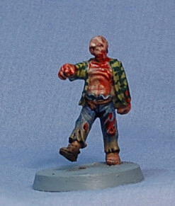 Painted zombie figurine on a gray base against a blue background.