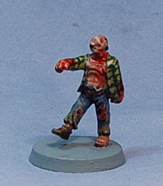 Photo of a painted zombie miniature on a gray base.